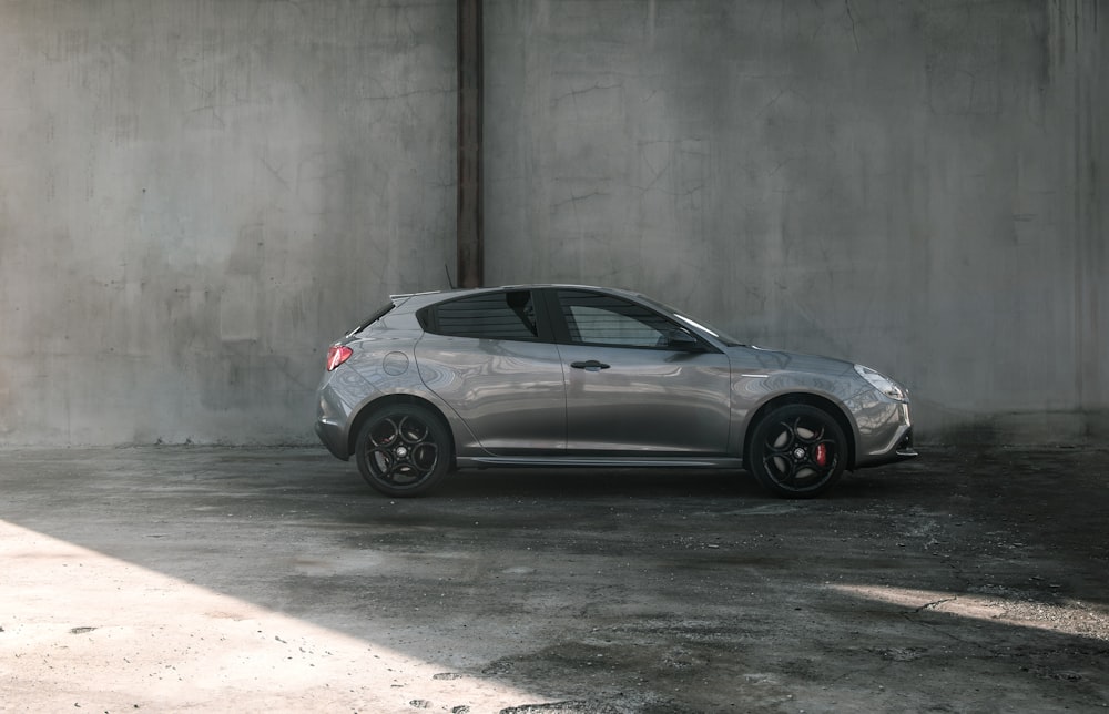 silver SUV parked near wall