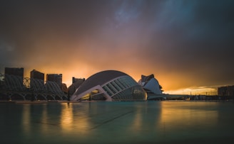 A futuristic city skyline blending ancient ruins with advanced technology under a twilight sky