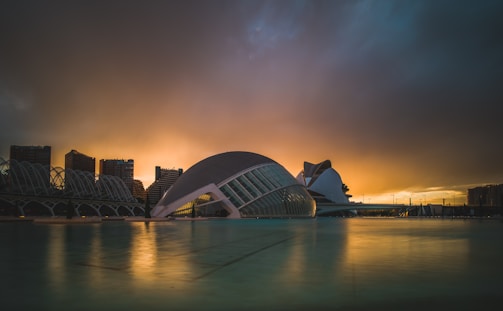 An artistic representation of a futuristic cityscape at sunset.