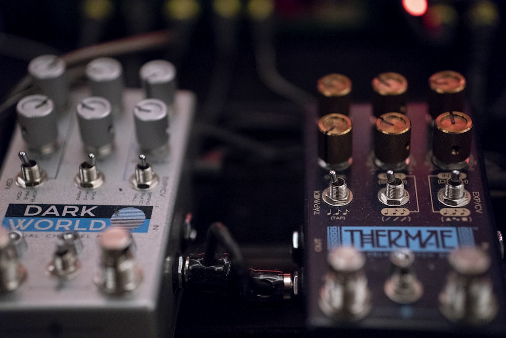 two silver and maroon guitar effects