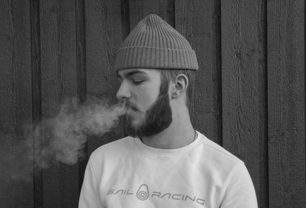 grayscale photography of bail racing sweatshirt and knit cap