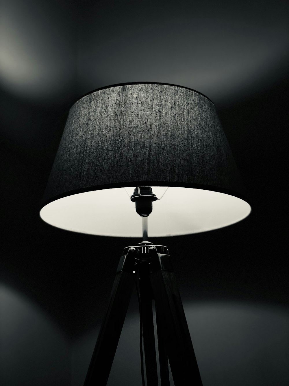 grey tripod floor lamp turned-on