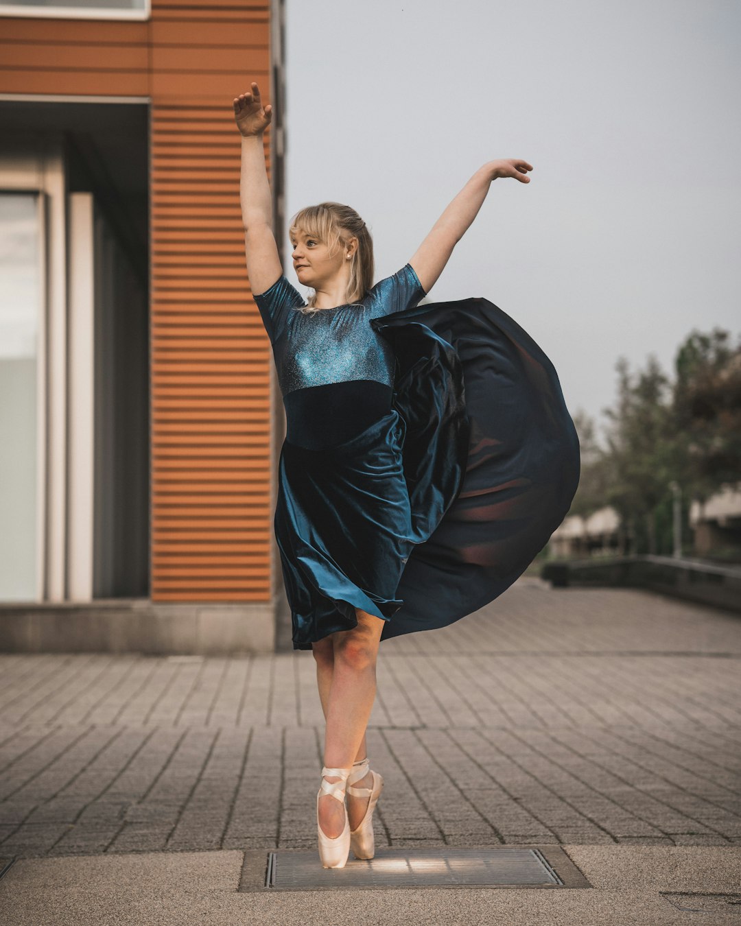 woman in blue and black short sleeved midi dress dancing