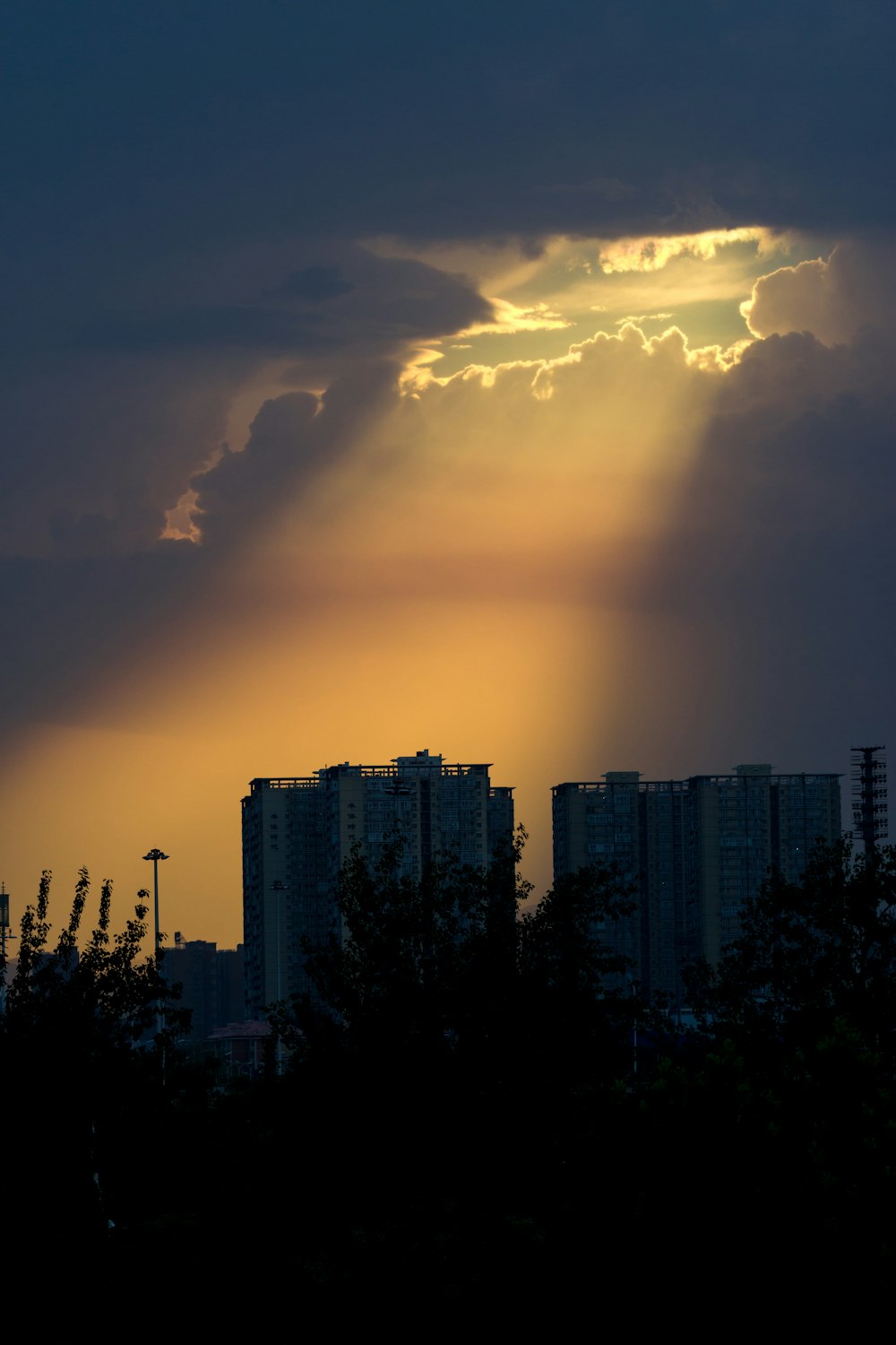 the sun is shining through the clouds over a city