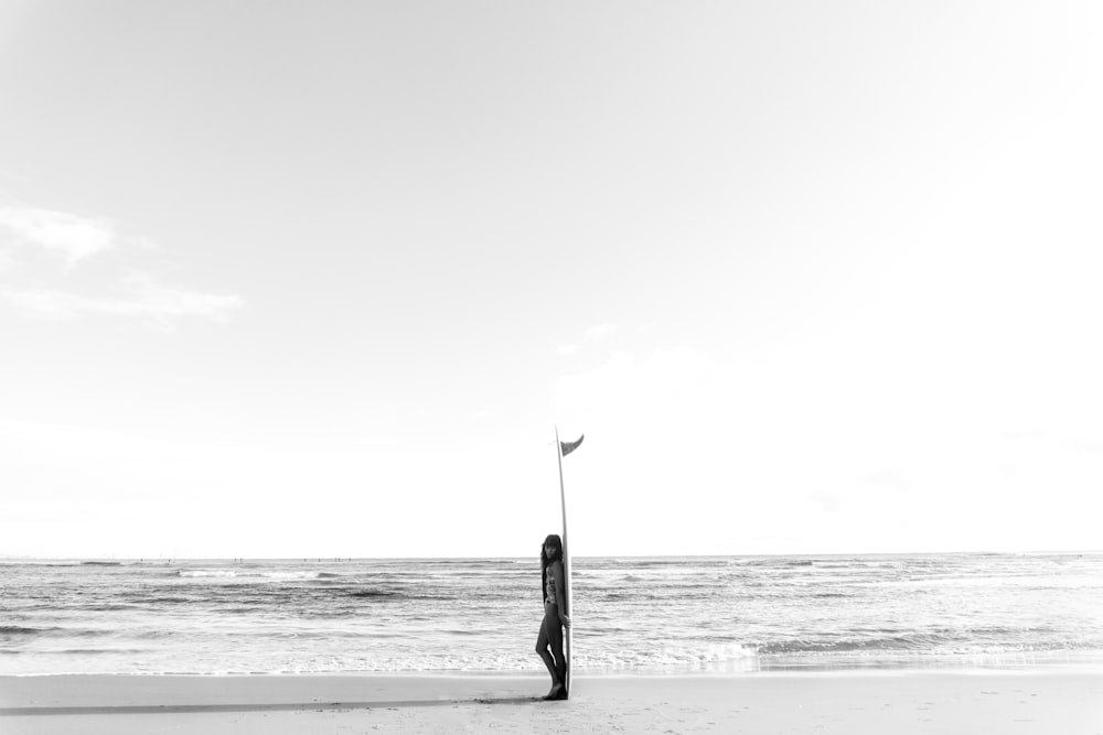 woman leaning on surfboard