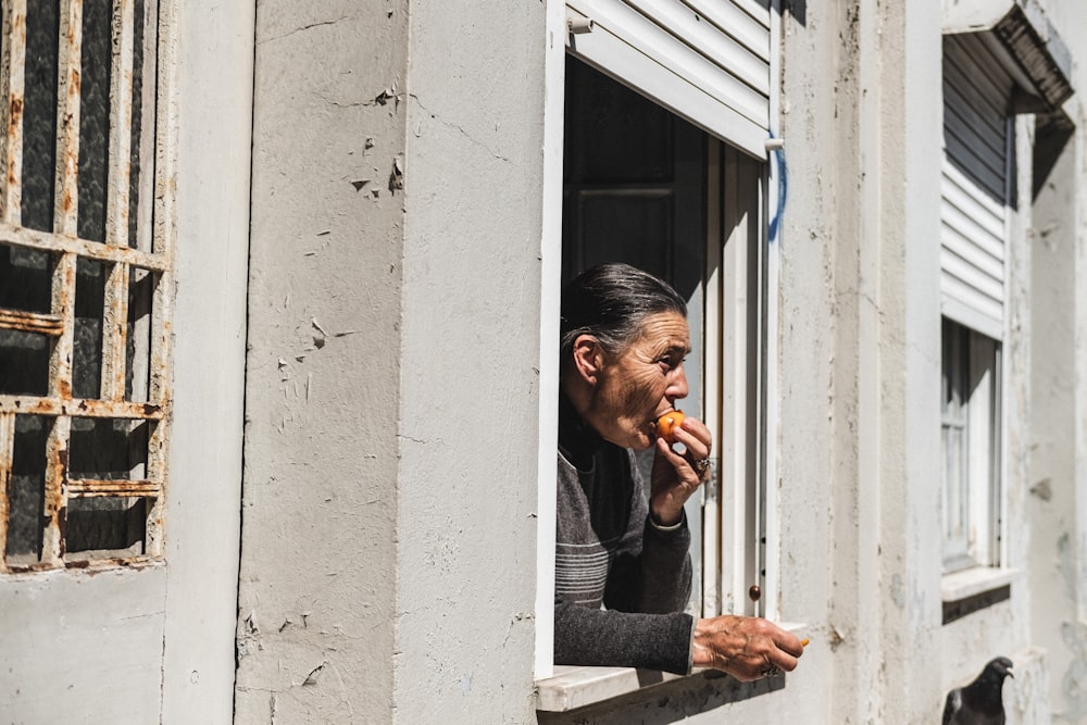 man eating food at the window