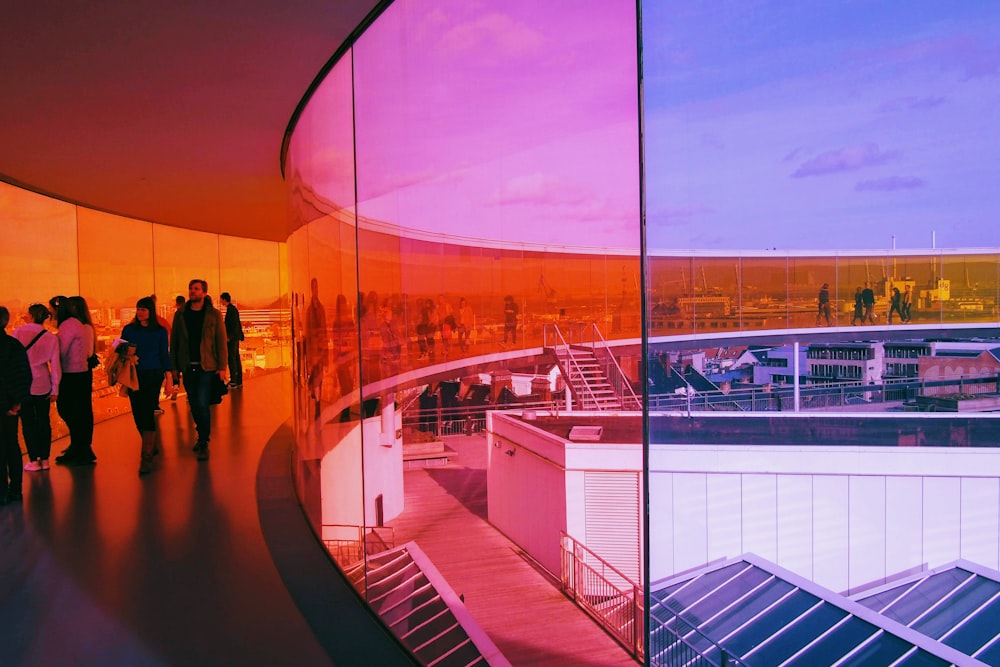 a group of people walking around a building