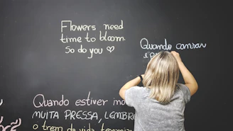 Teacher explaining Portuguese grammar to attentive students in a bright classroom.