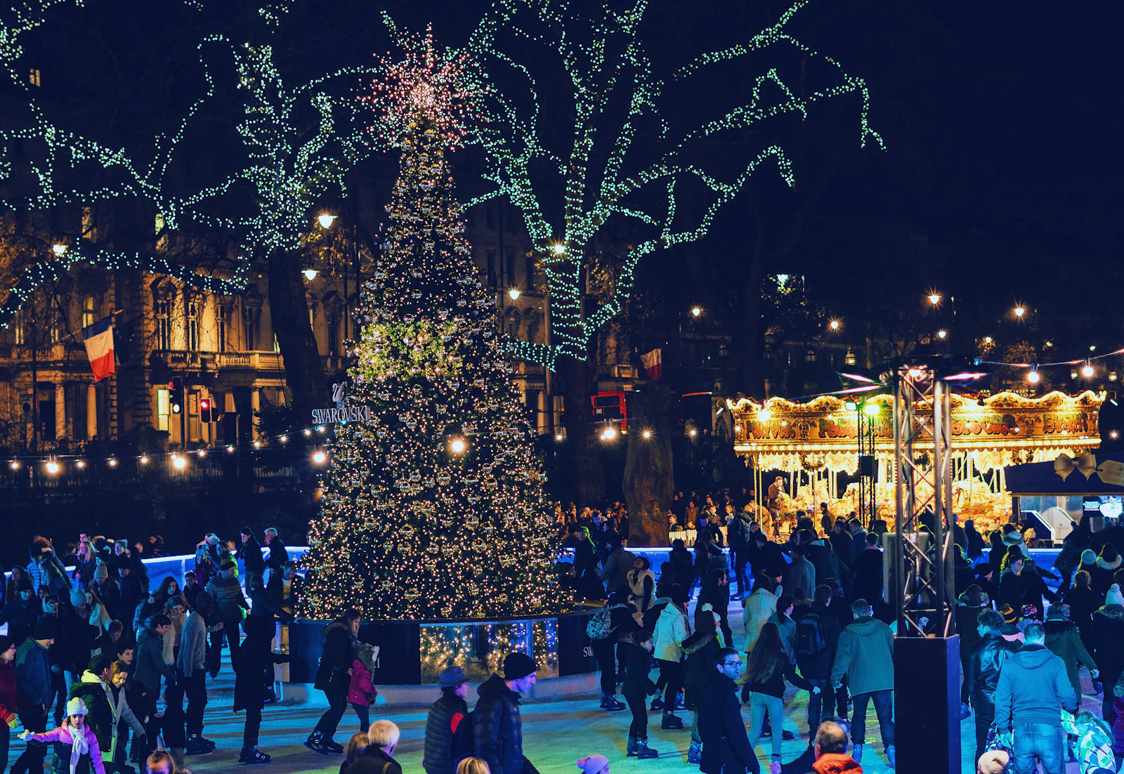 Christmas market with a lit Christmas tree at night