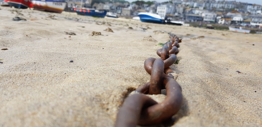 black metal chain on brown sand