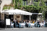 Cozy outdoor tables with people enjoying aperitivi on a sunny afternoon