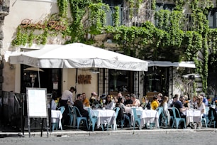 Sunlit outdoor garden area with people enjoying lunch and aperitivo at ritorno.