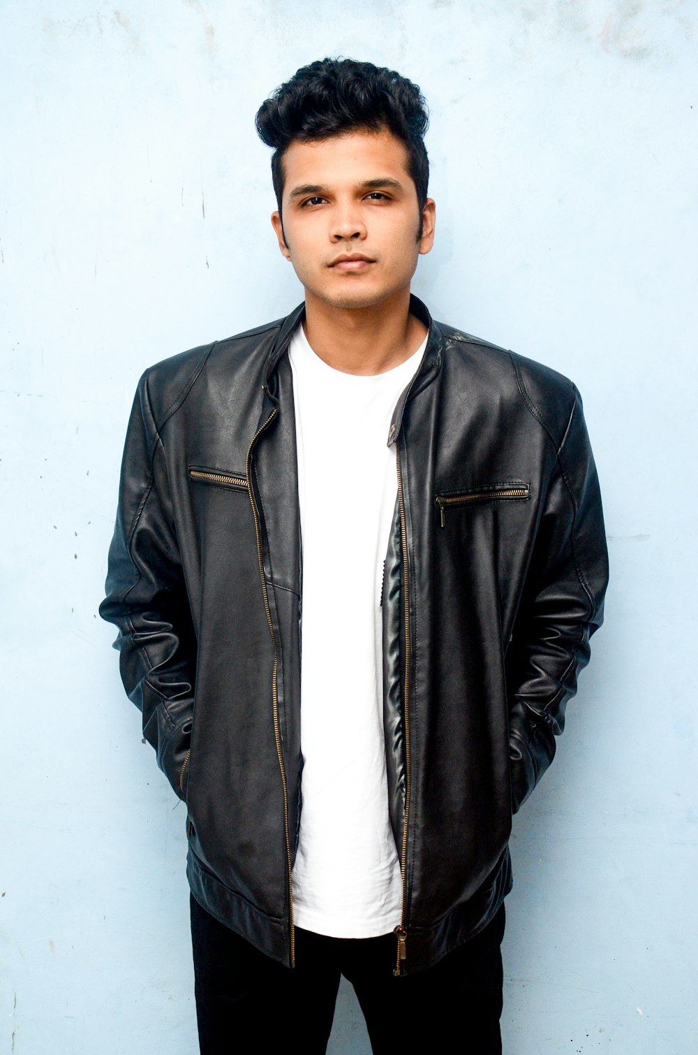 man wearing white shirt and black leather jacket