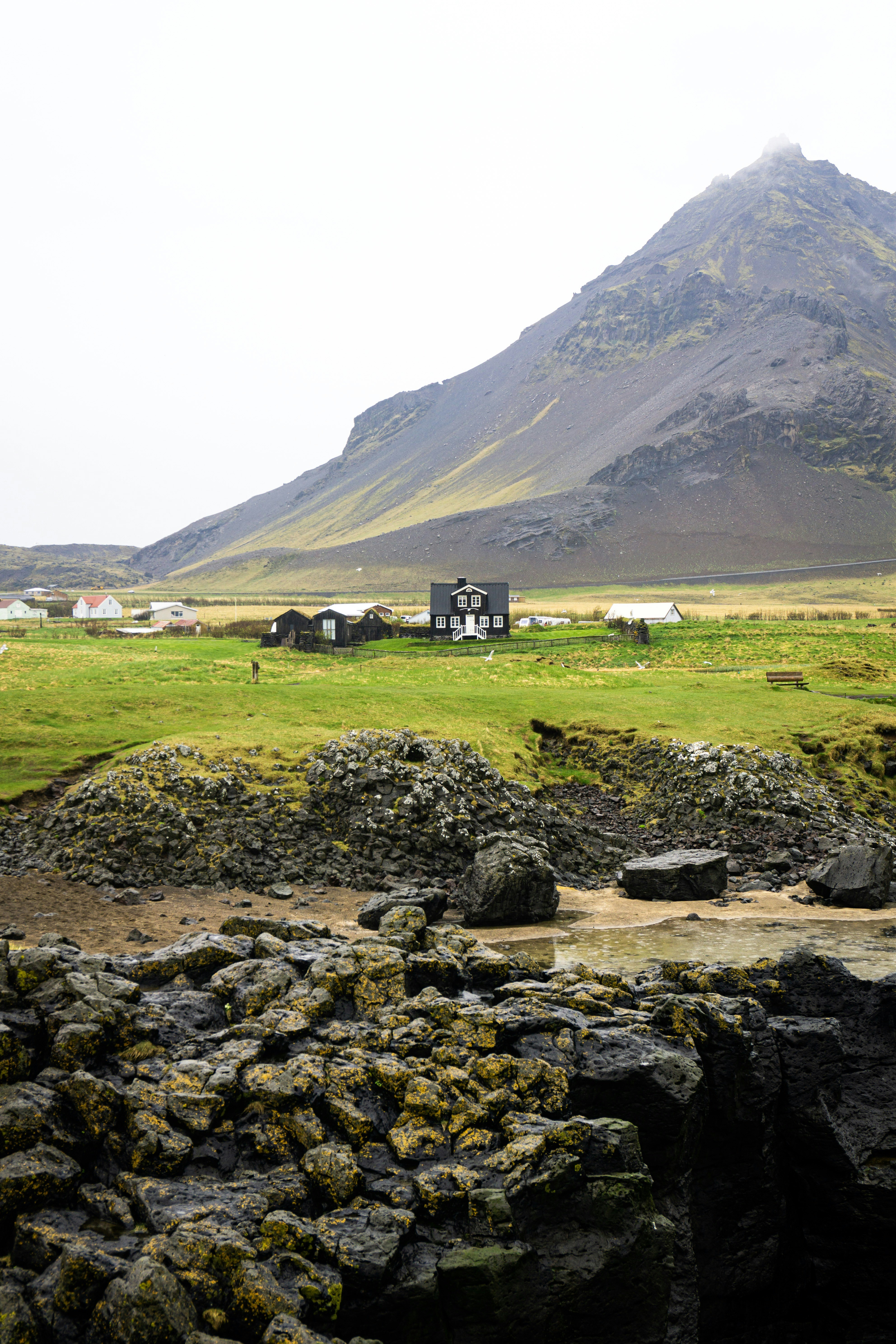 houses beside mountain during daytime
