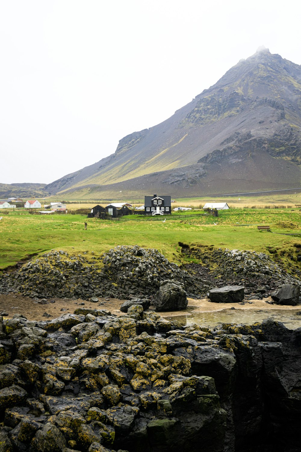 houses beside mountain during daytime