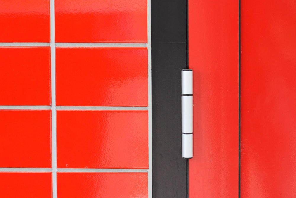 a close up of a red door with a white handle