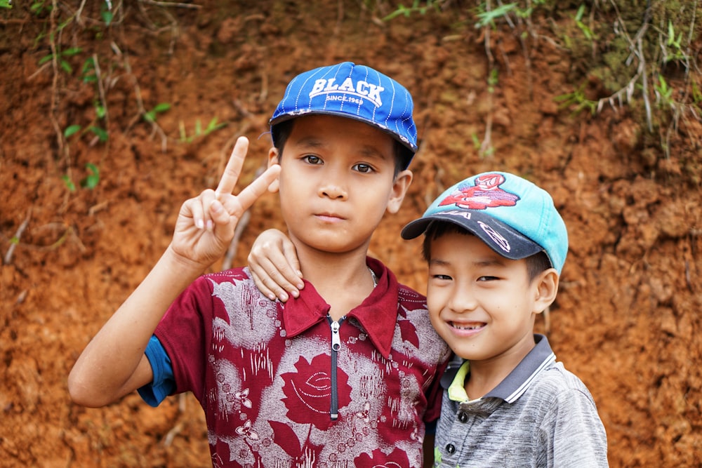 two boys standing near mountain