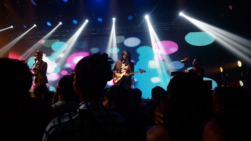 group of men standing on stage while performing