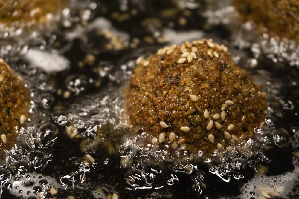 fried meat balls with sesame seeds on top