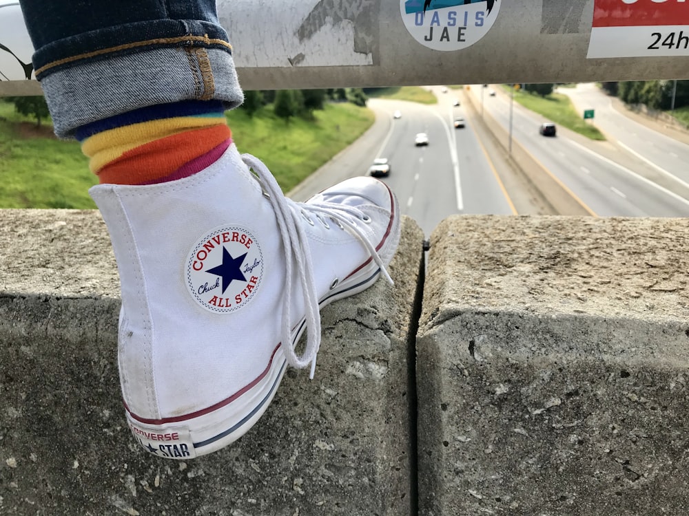 unpaired white Converse high-top sneaker