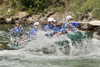 A group whitewater rafting on a river near Moab
