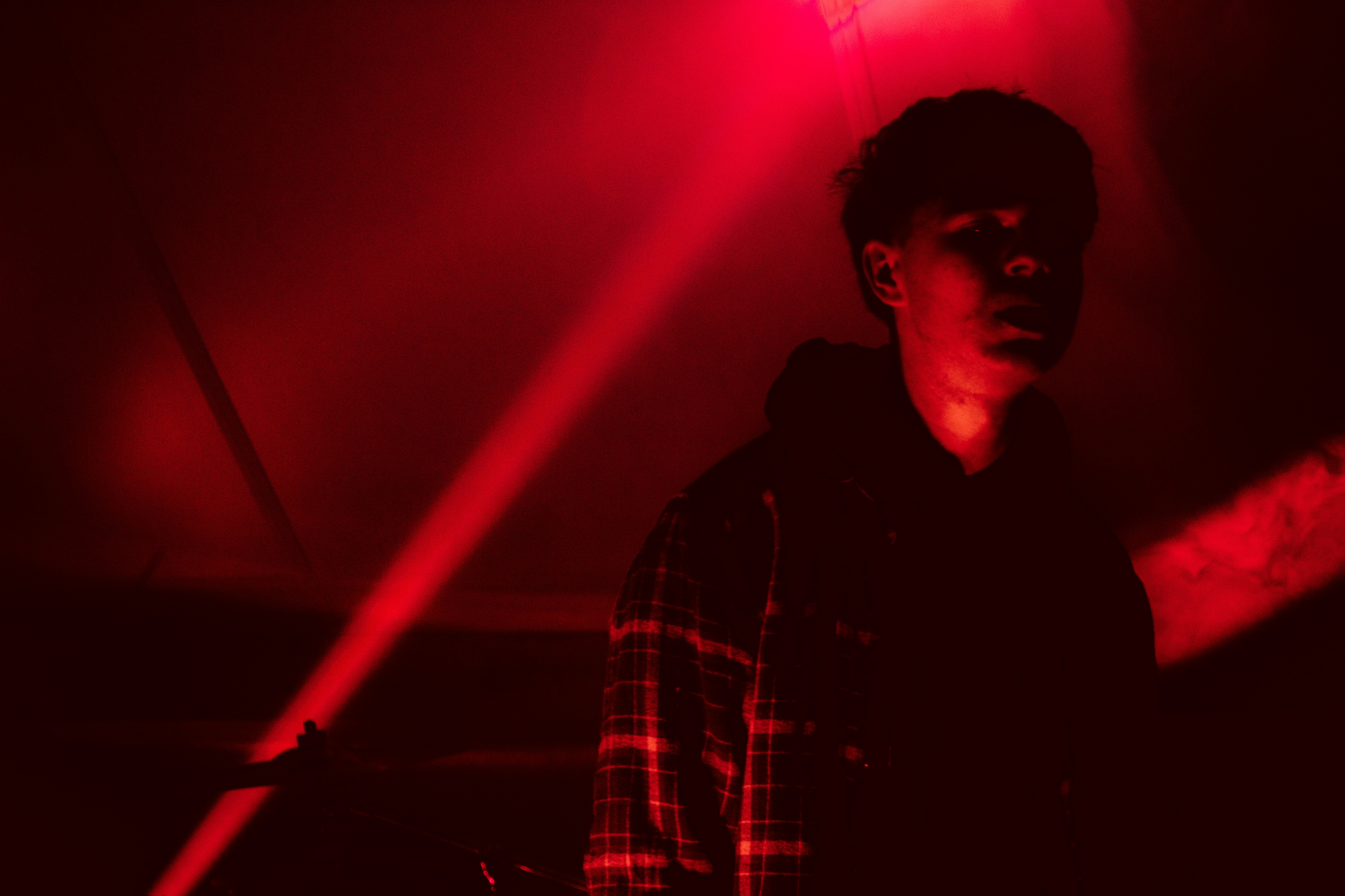 man in red lit room