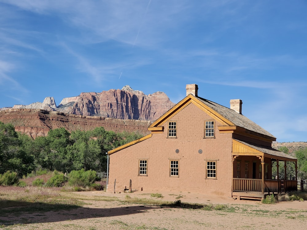 brown concrete house near mountain