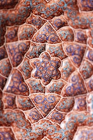 low-angle photography of red, blue, and teal floral ceiling