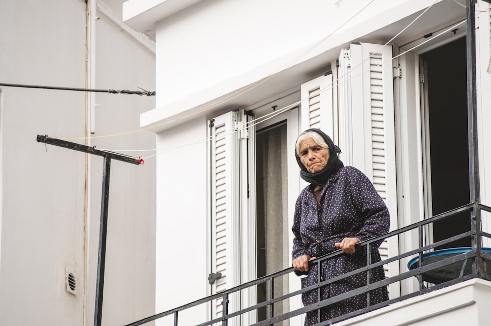 woman standing near open window