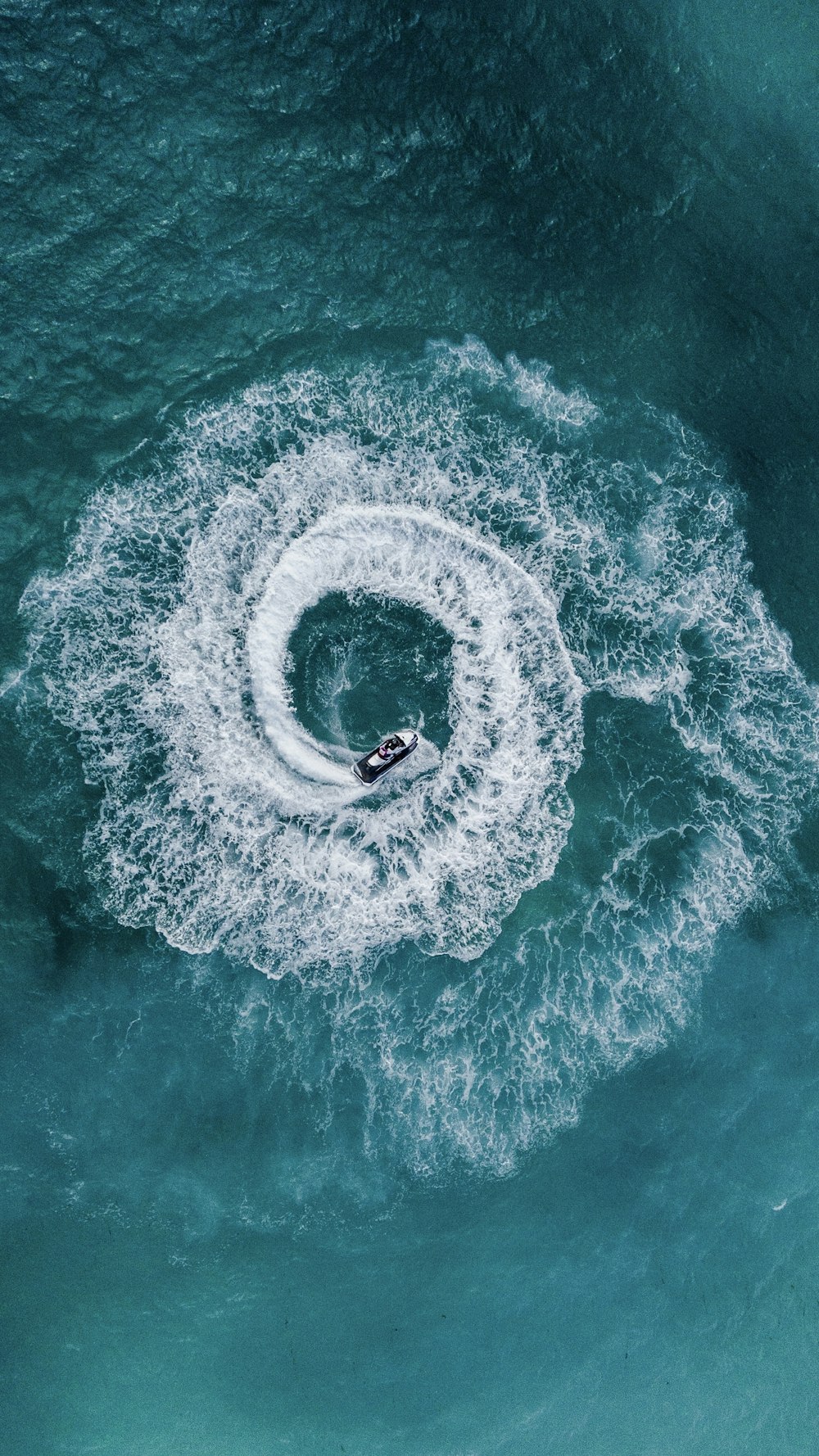 person driving personal watercraft during daytime