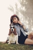woman sitting beside the basset hound