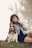 woman sitting beside the basset hound