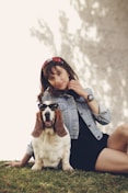 woman sitting beside the basset hound
