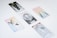 Several tarot cards are spread out on a white surface. Each card features unique illustrations, such as a lion, a crescent moon with forest trees, a pair of flying birds, a deer beneath a rainbow, and two intertwined sticks.
