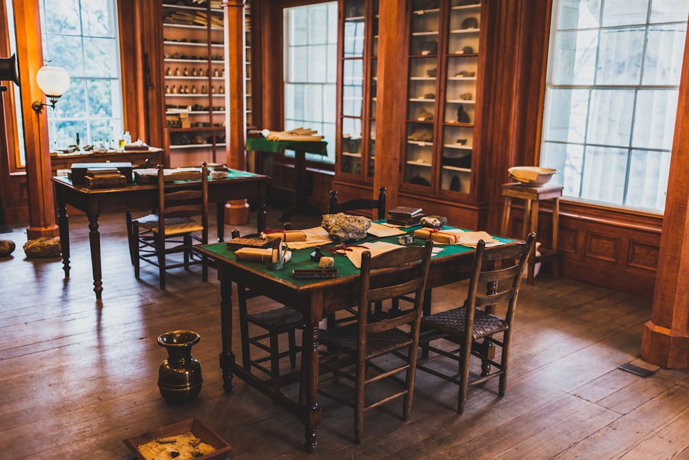 rectangular green and brown wooden table near window