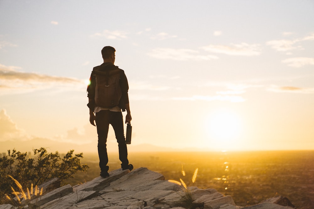 man standing on cliff