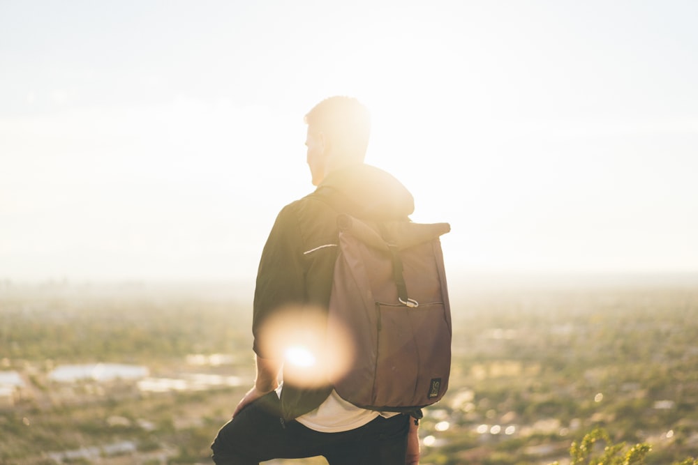 man carrying backpack