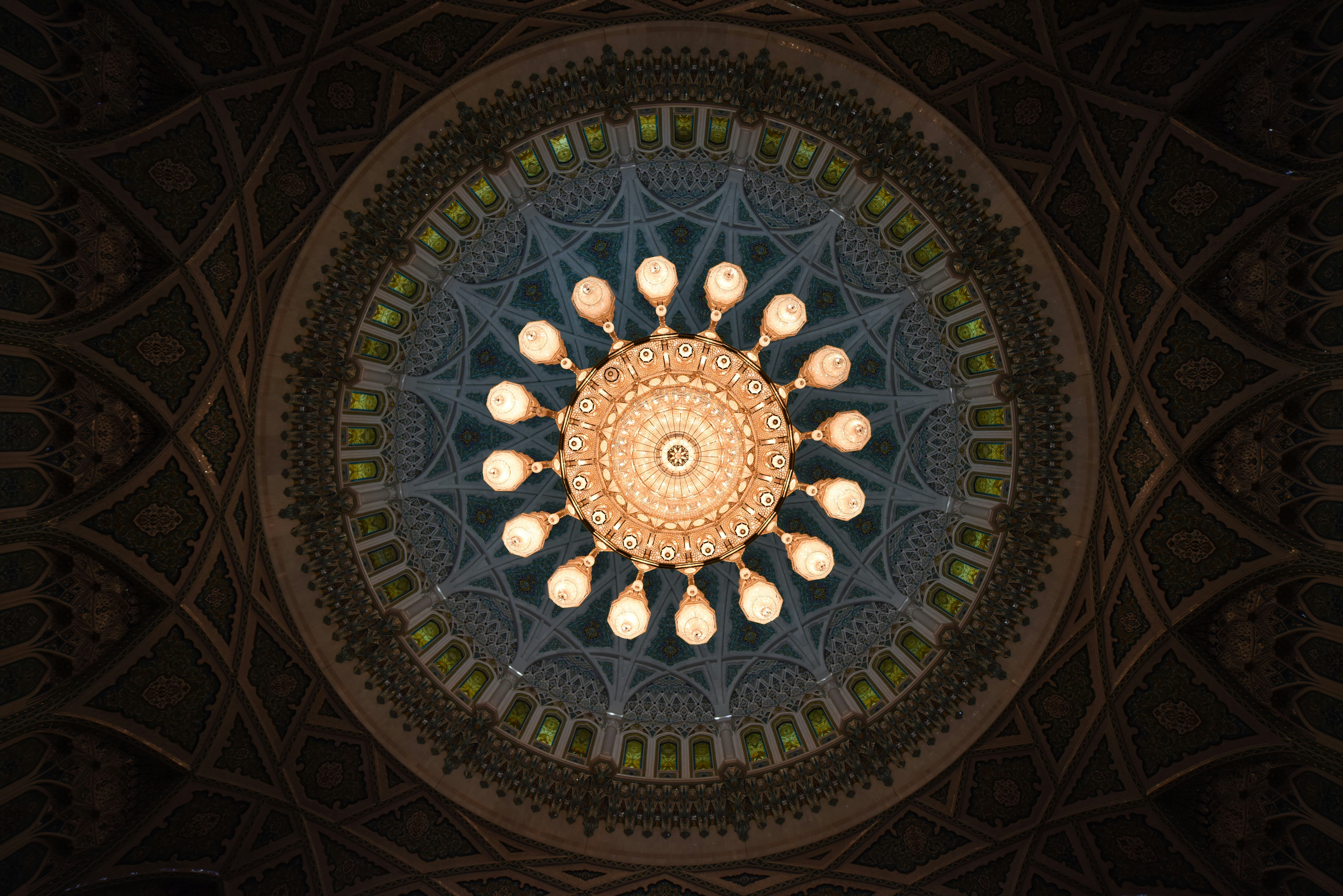 amber and brown chandelier, The sheer scale of this chandelier must be seen to be believed. The enormous bejeweled light measures 45 feet tall and 26 feet wide, and weighs around 9 tons. It’s decorated with 600,000 pieces of crystal trimmed with gold, and even has a small staircase inside it for workers to perform the maintenance needed to keep its 100-plus lamps shining bright.
