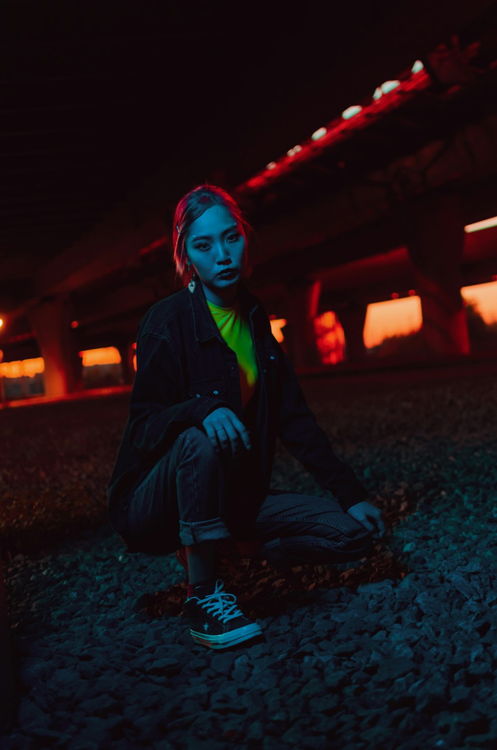 woman sitting on grey pavement