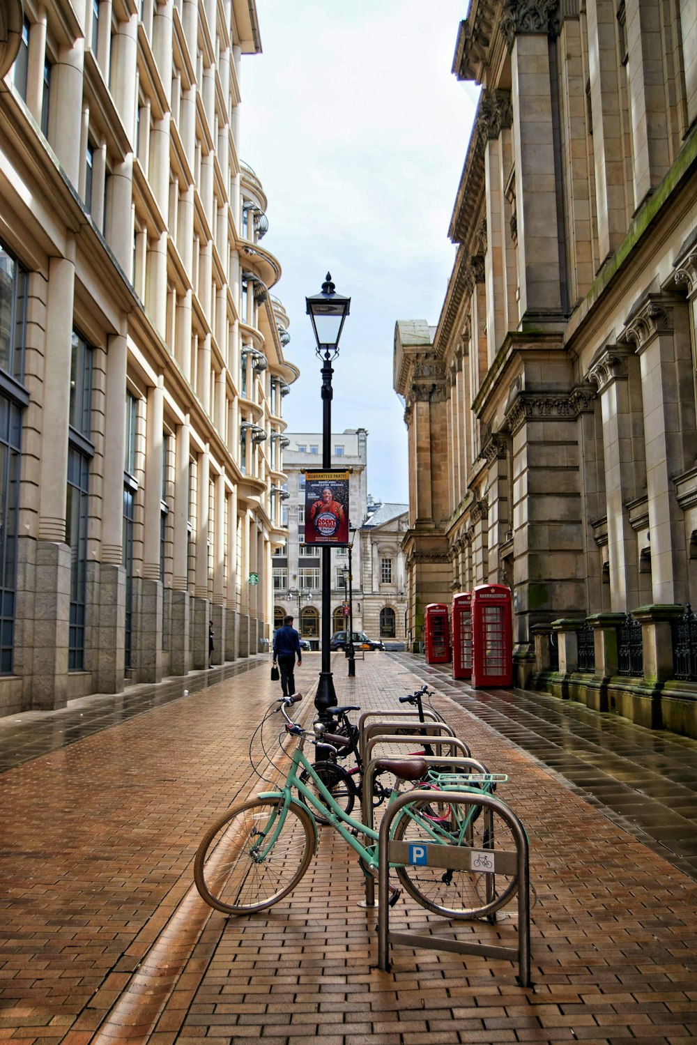 teal commuter bike parked beside buildings