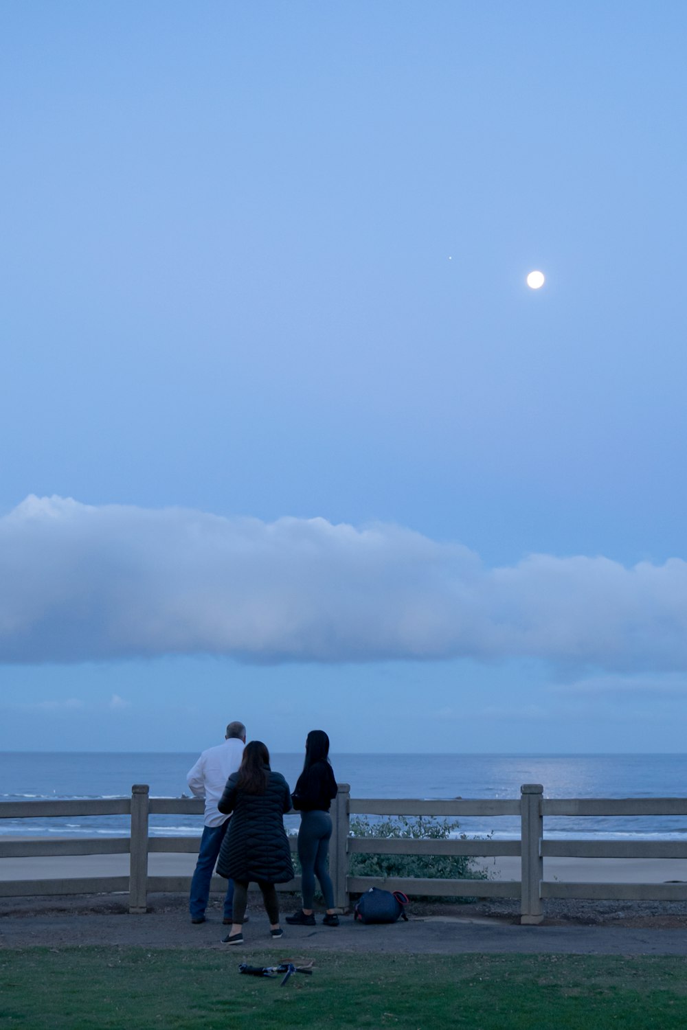 people standing near wooden fence