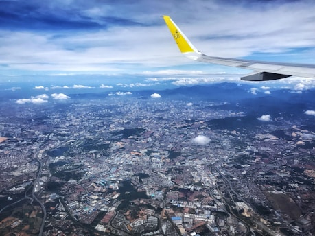 A vibrant aerial view of a bustling Indian city integrating green spaces with advanced aviation technology.