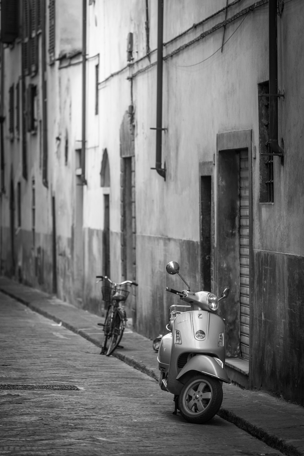 two empty bicycle and scooter on road side