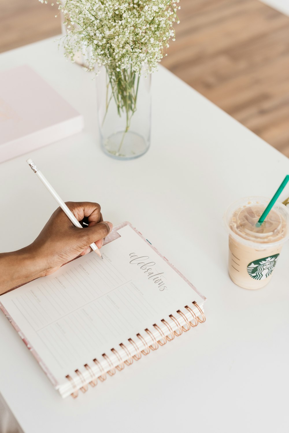 person writing on notebook