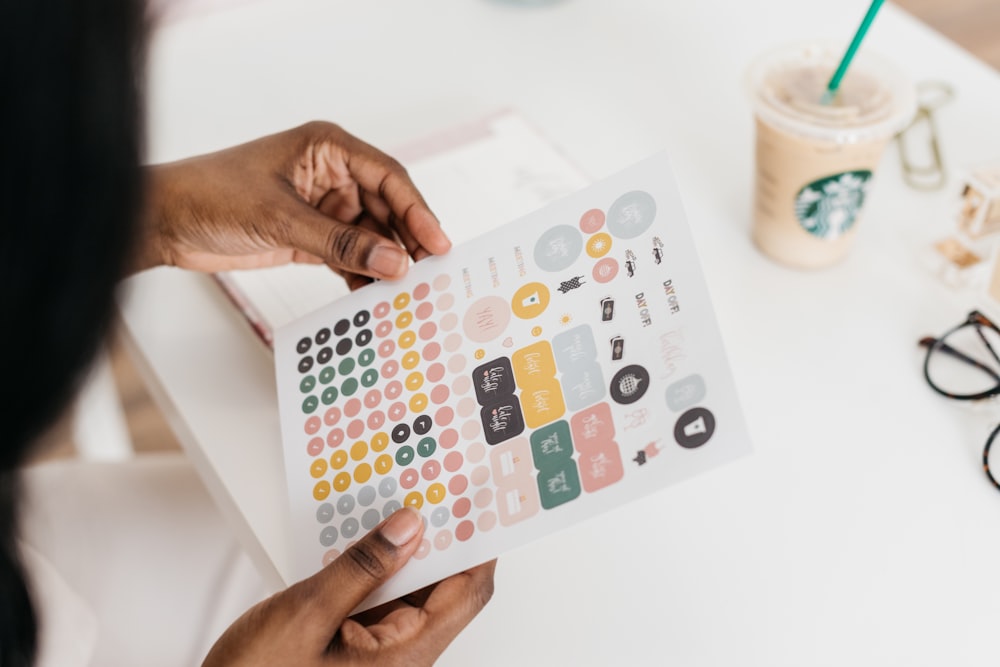 person holding white printing paper