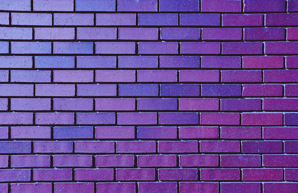 a close up of a purple brick wall