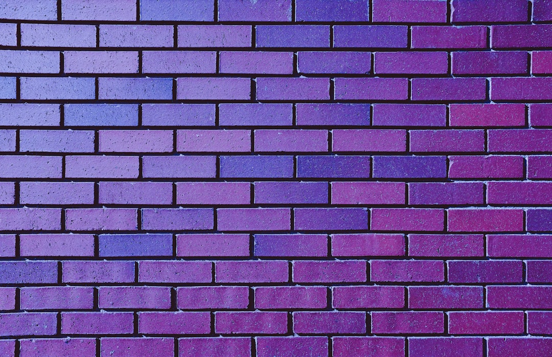 a close up of a purple brick wall|600