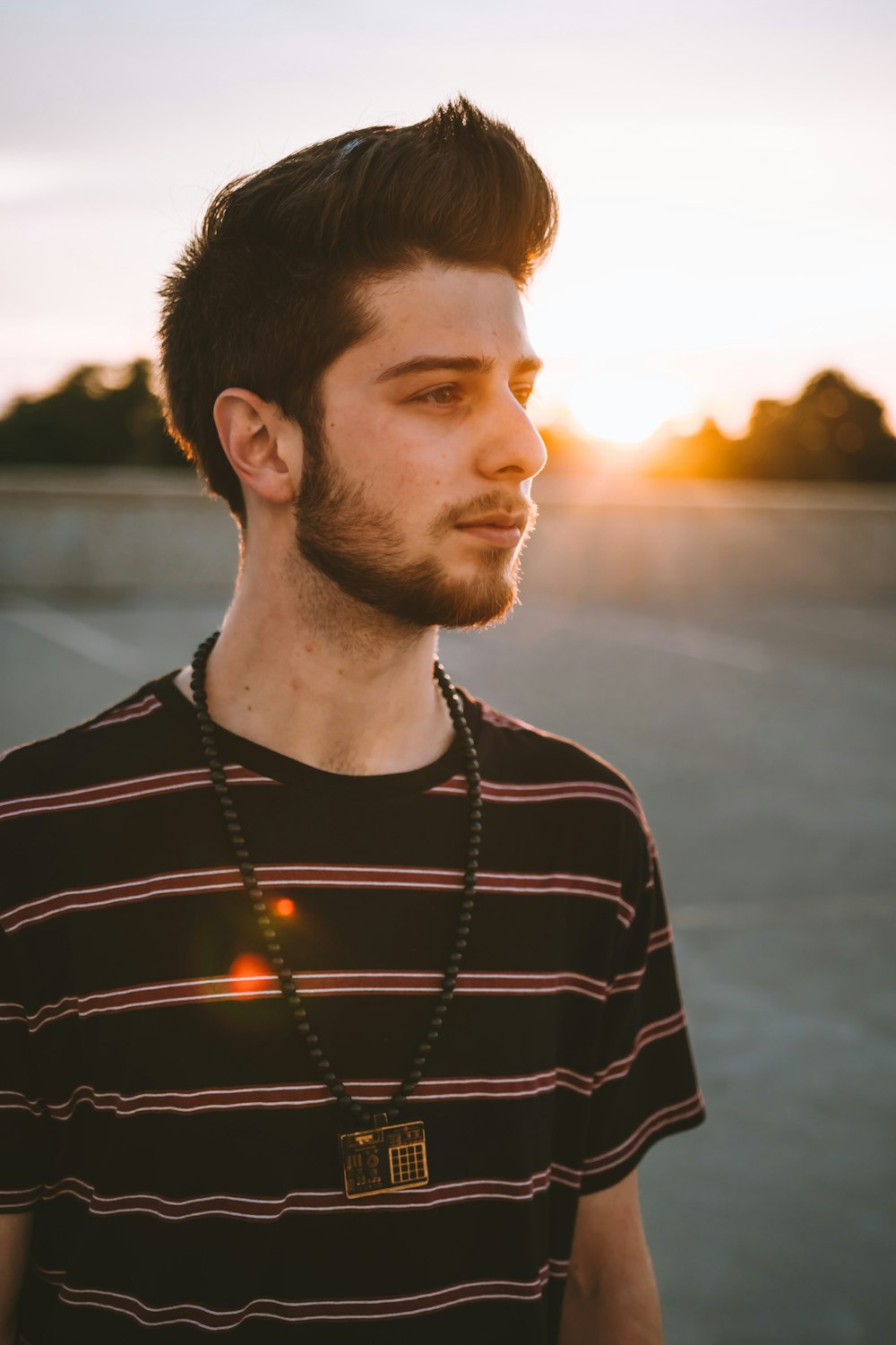 man wearing black shirt and necklace