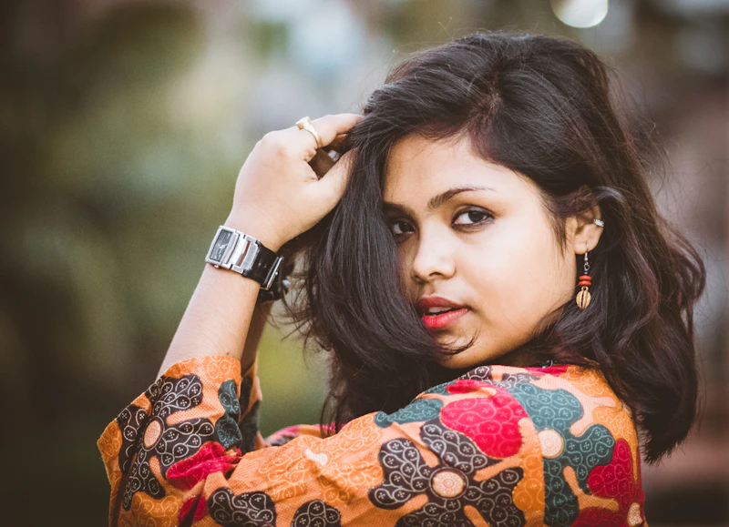 woman holding her hair with effortless charm