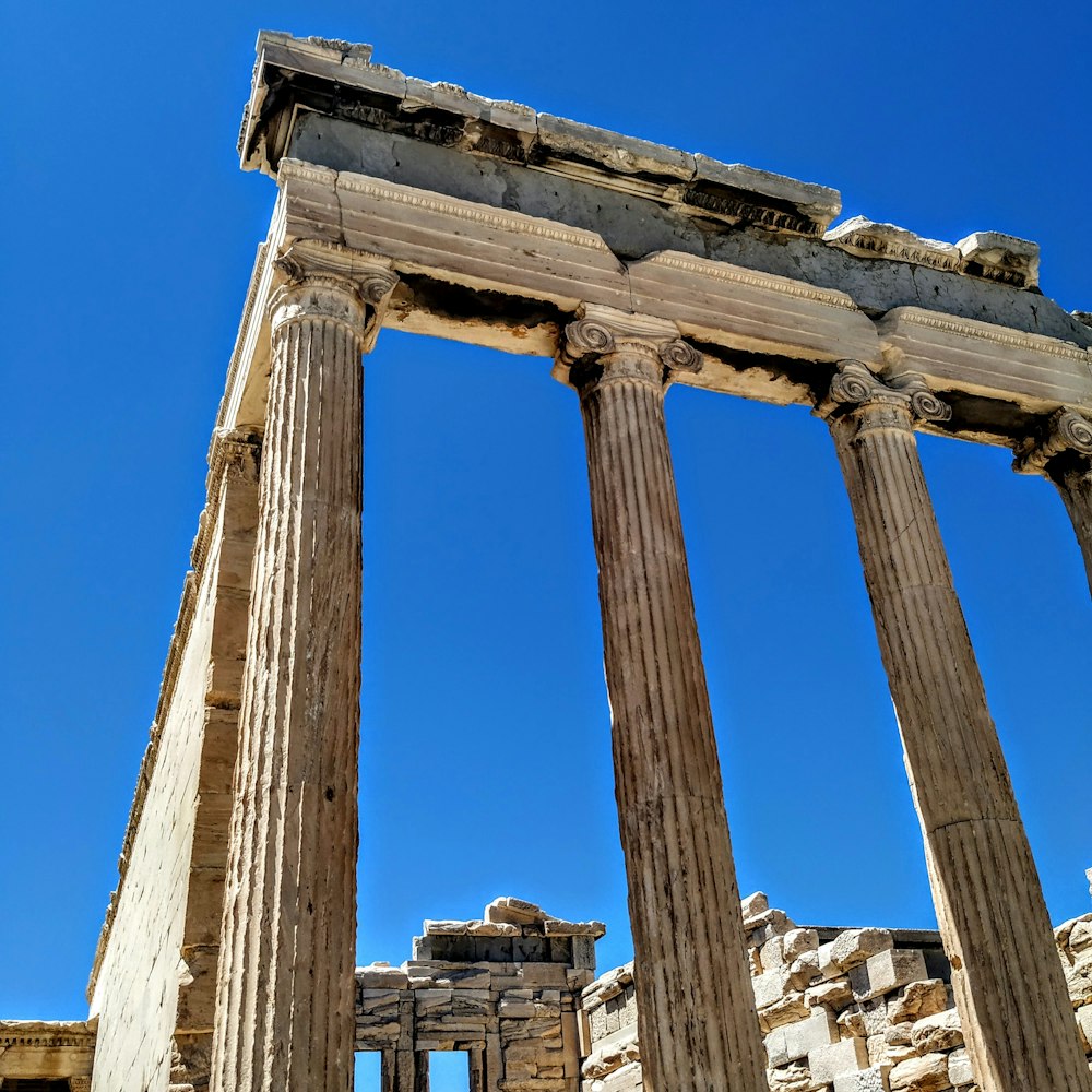 brown pillars ruins under clear blue sky